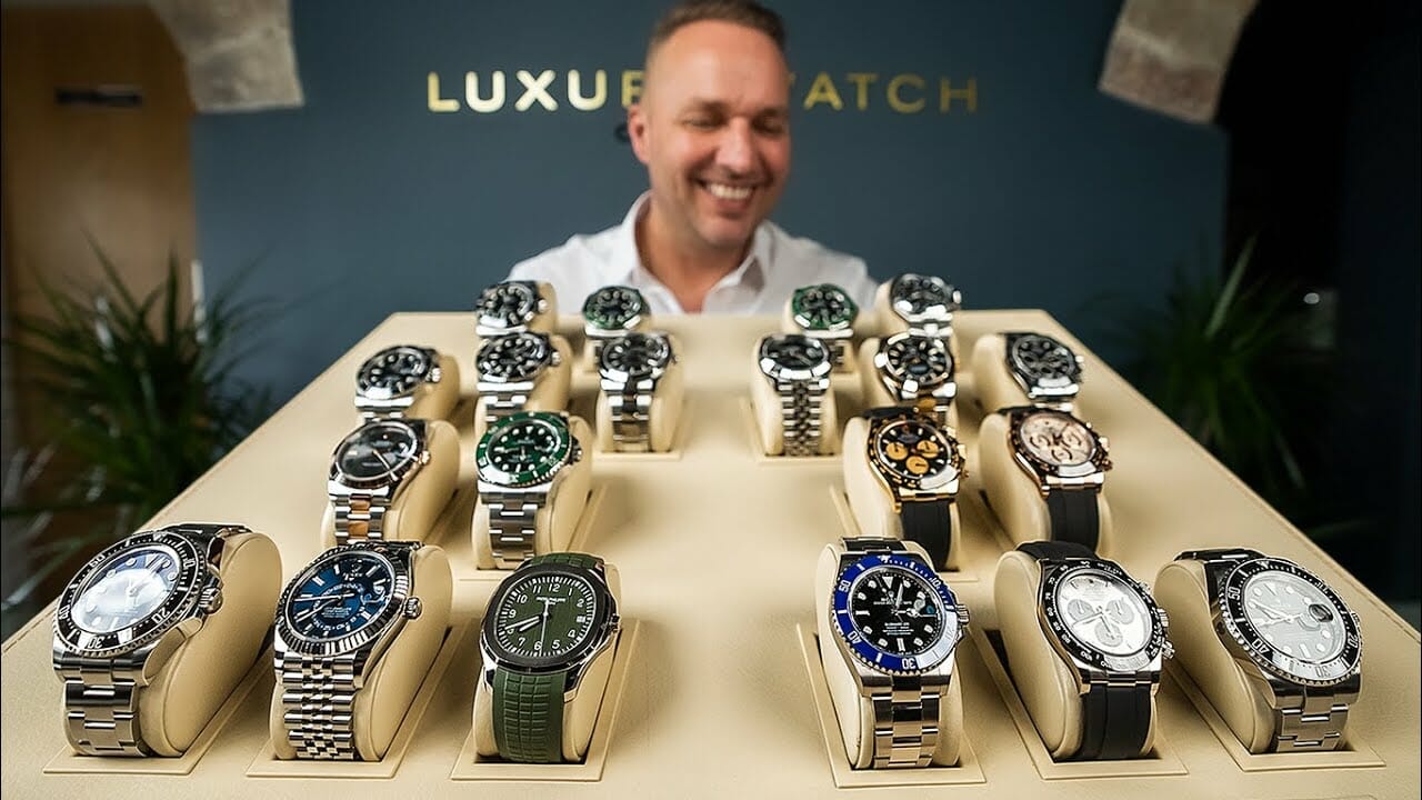 man inspecting luxury watches inside the box
