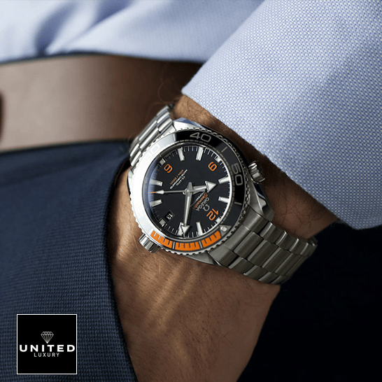 Omega Black Dial Orange Bracelet Oyster Replica on the man in the suit