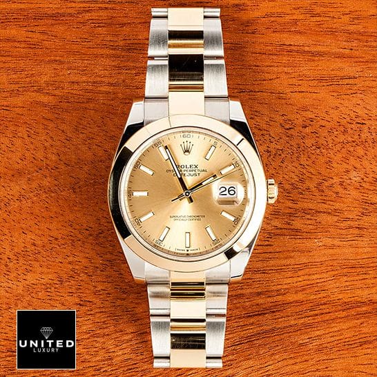 Rolex Datejust 126303 Gold Dial Replica on a wooden table