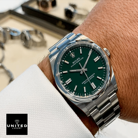 Rolex Oyster Perpetual Green Dial 126000 Replica on his arm