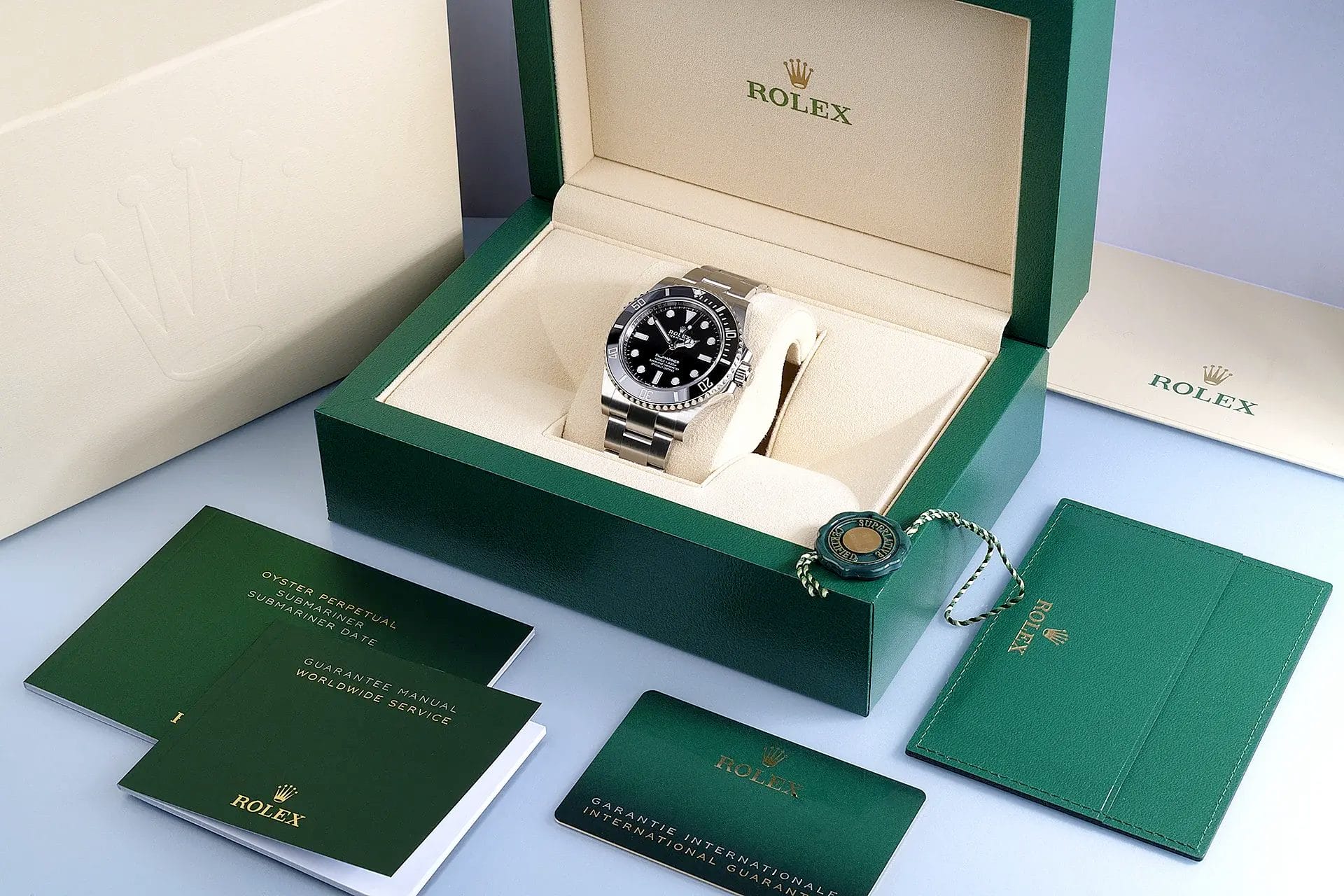 rolex submariner on box with warranty card
